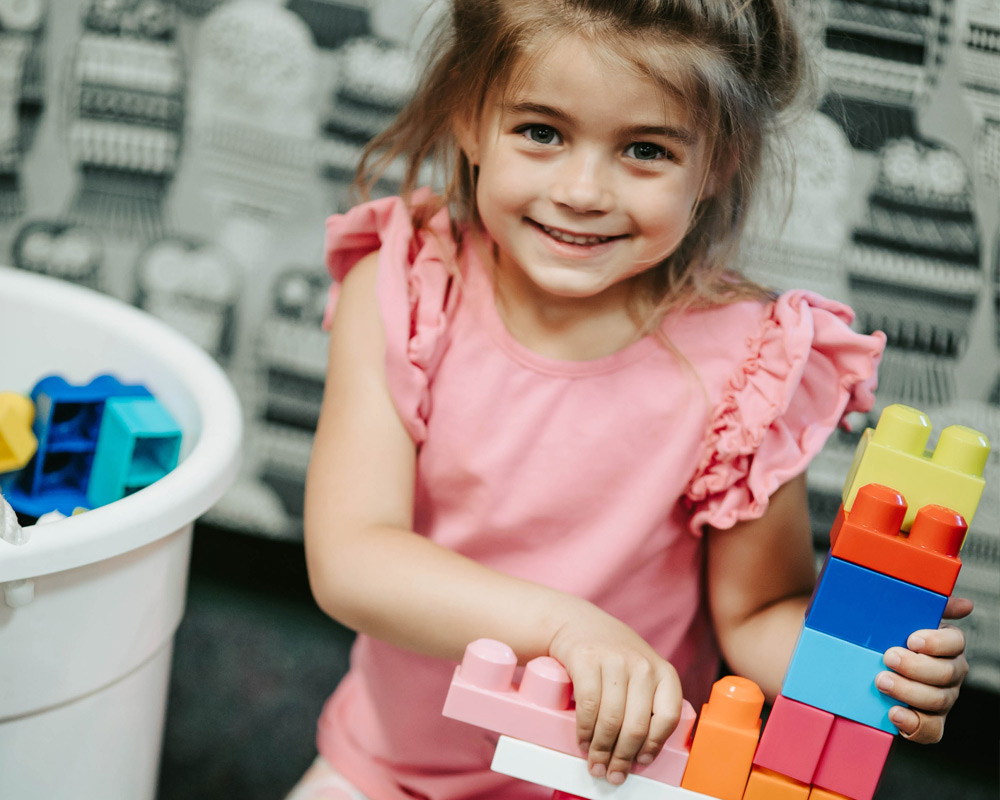 Preschool girl with Megablox tower
