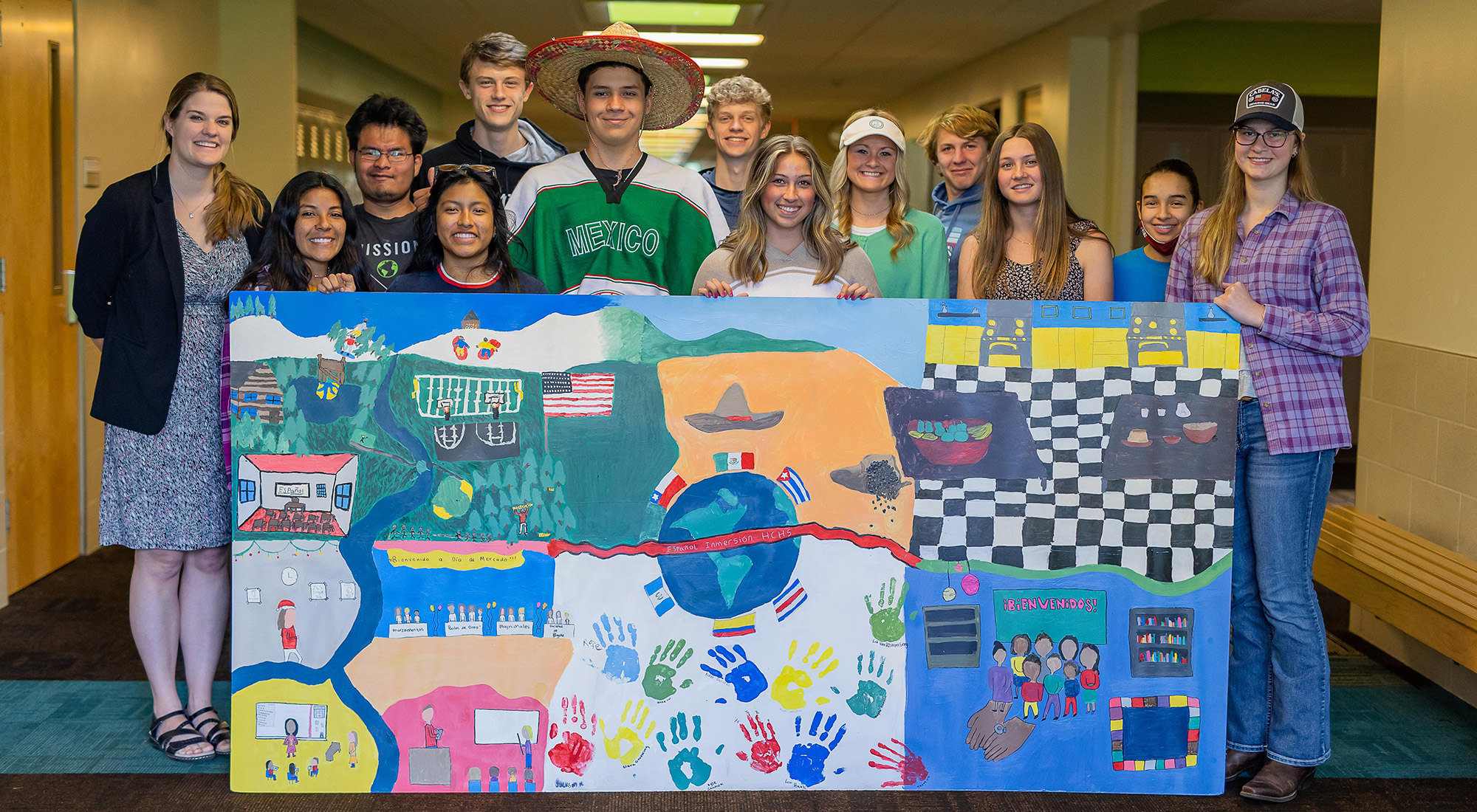 HCHS Spanish Immersion students posing behind a large mural they painted