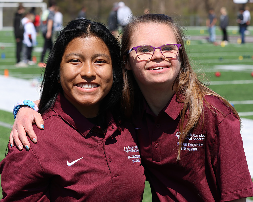 Two HS girls from Unified bocce ball team smiling at the camera together
