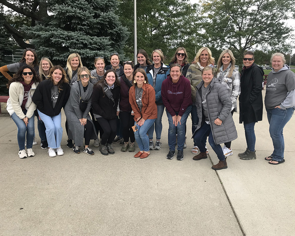 Walkathon helper moms in long coats smiling at the camera