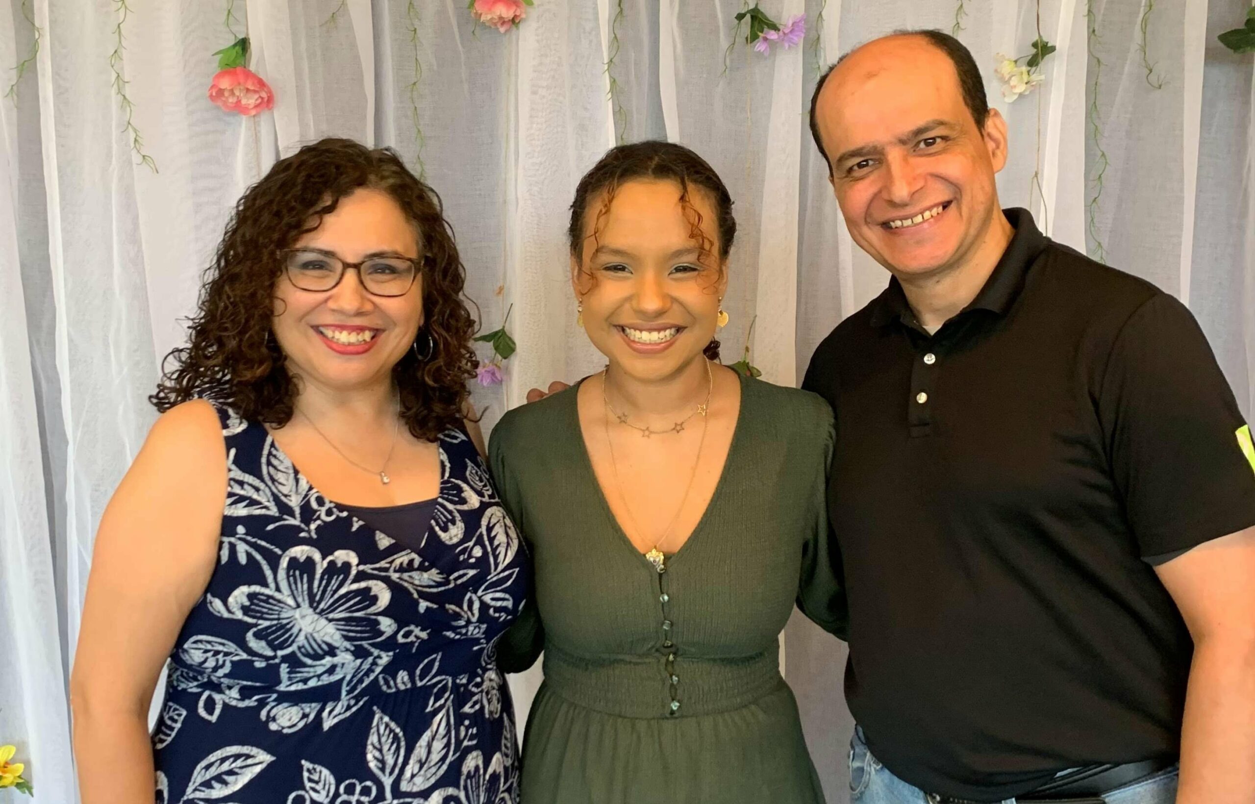 The Rodriguez family smiling at the camera.