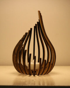 A wooden candle holder shaped like a flame.