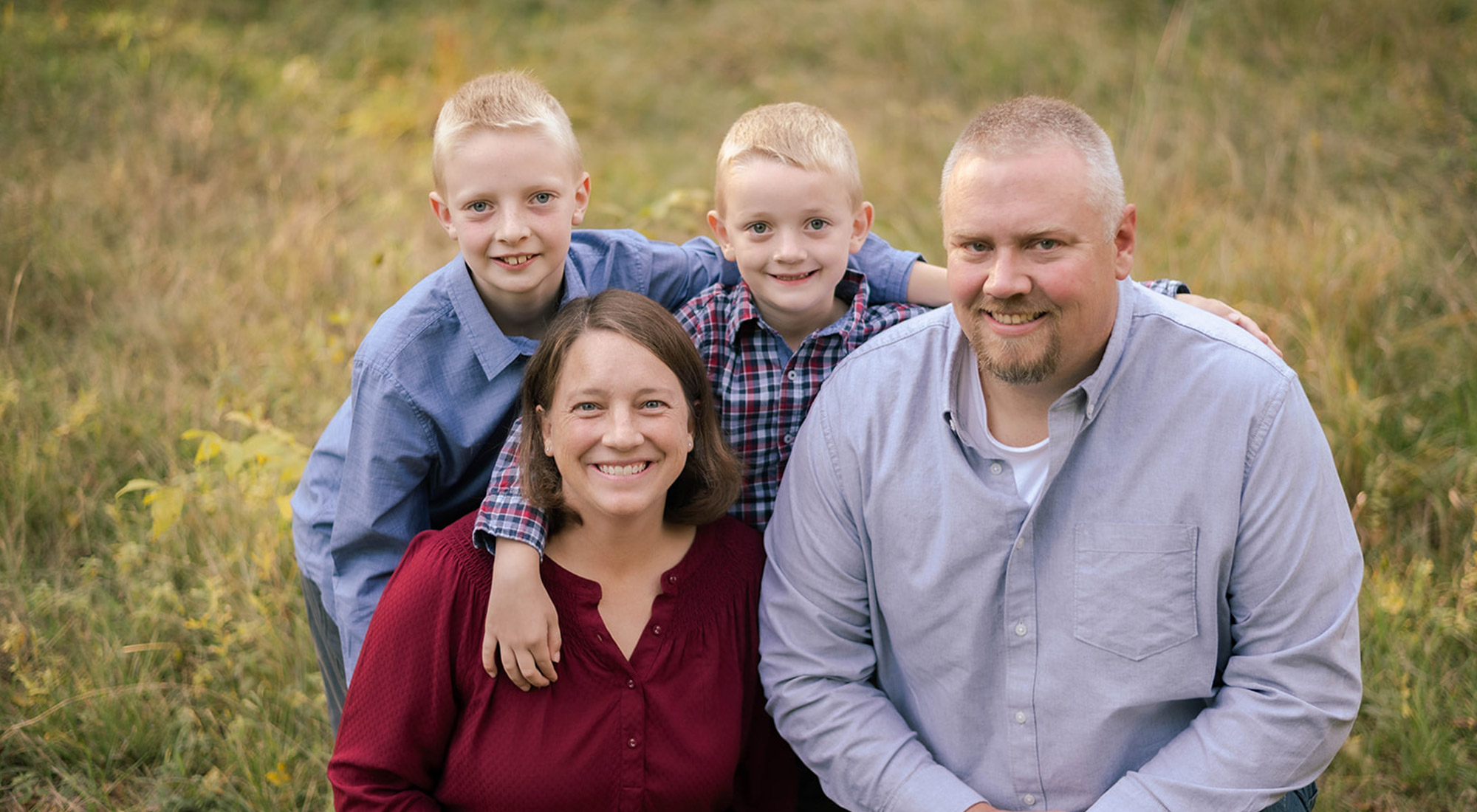 The four members of the Styf family smiling at the camera.