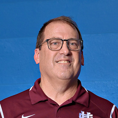 Coach Todd Smenge smiling at the camera