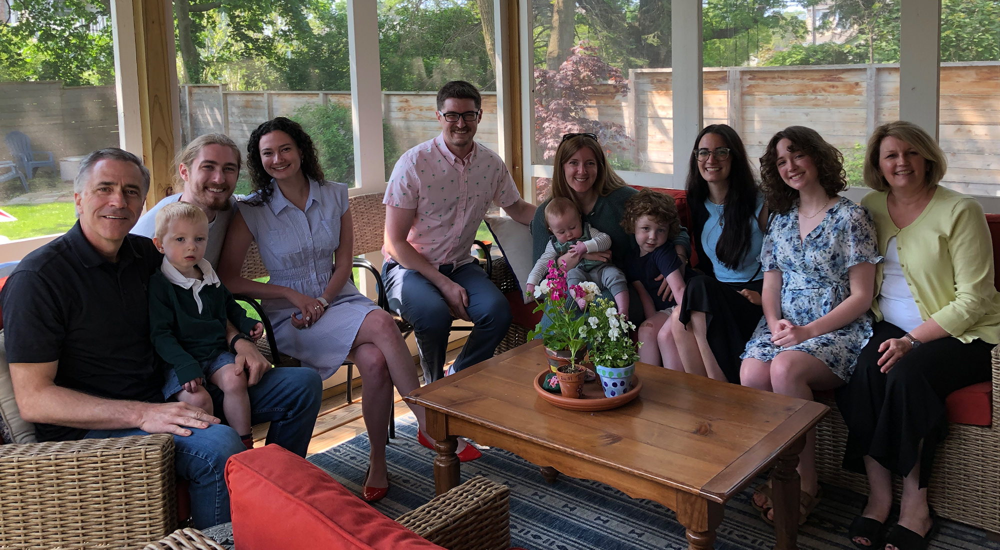 Members of the Jackson family sitting in a porch smiling at the camera.