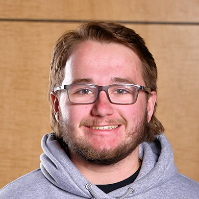 JV boys lacrosse coach posing for the camera.