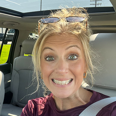 Sarah Terpstra smiling in her car.