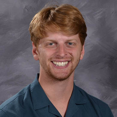 Sam Hofman smiling at the camera
