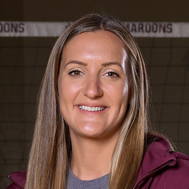 Coach Anna Timmerman smiling at the camera.