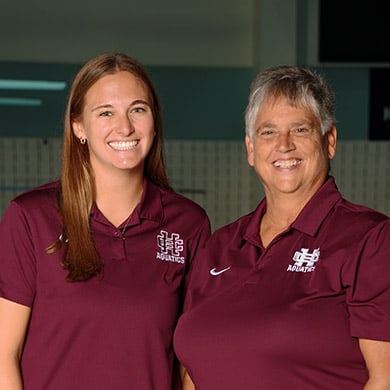Coach Slenk smiling at the camera, dressed in maroon.