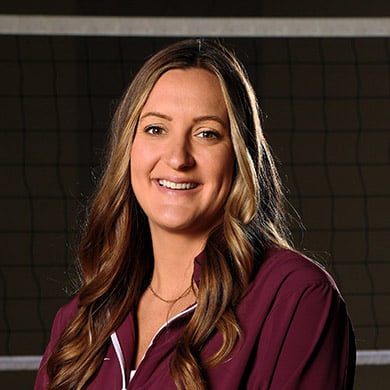 Coach Anna Timmerman smiling at the camera.