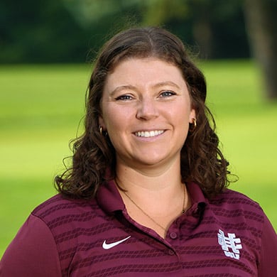 Coach Nienhuis smiling at the camera.