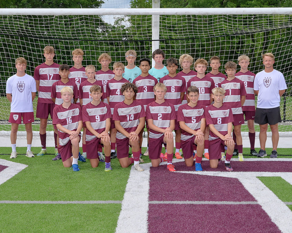Boys JV soccer team smiling at the camera.