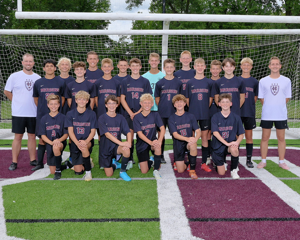 Freshman boys soccer team smiling at the camera.