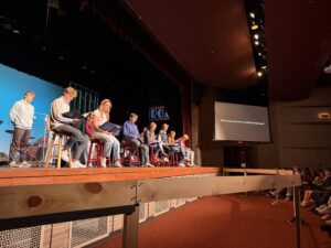 students on stage playing guitars