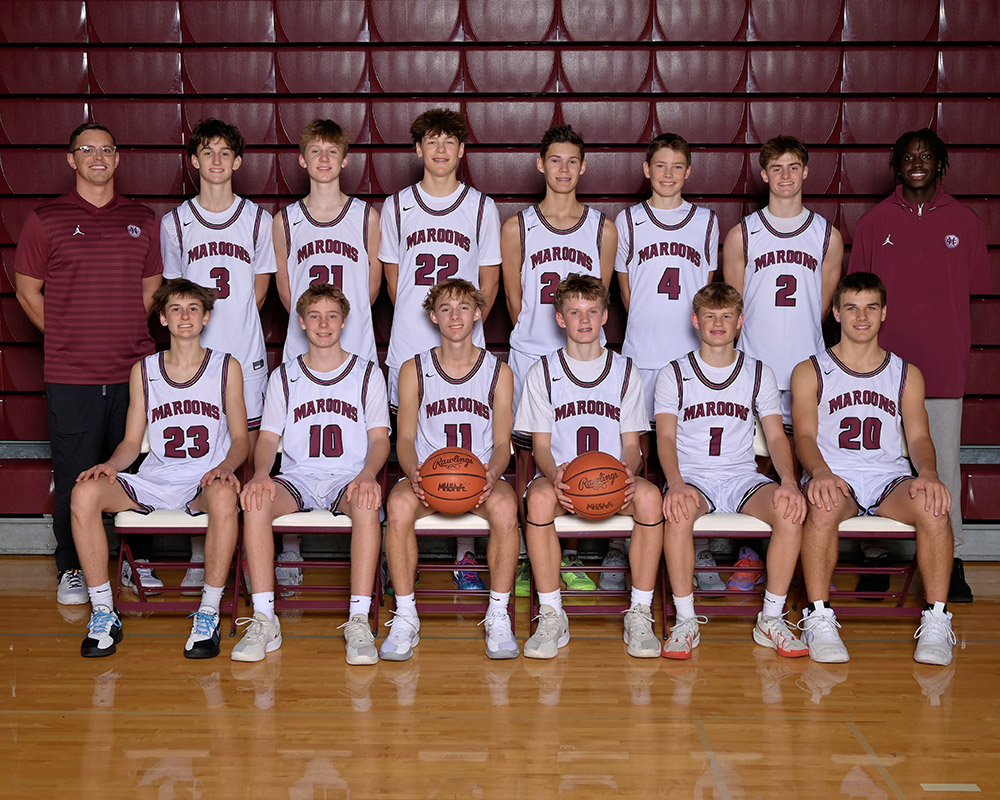 JV boys basketball team smiling at the camera
