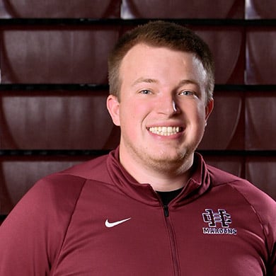 Freshmen boys basketball coach smiling at the camera