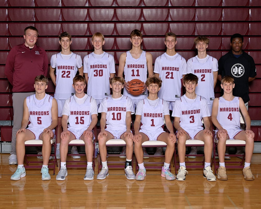 freshmen boys basketball team smiling at the camera