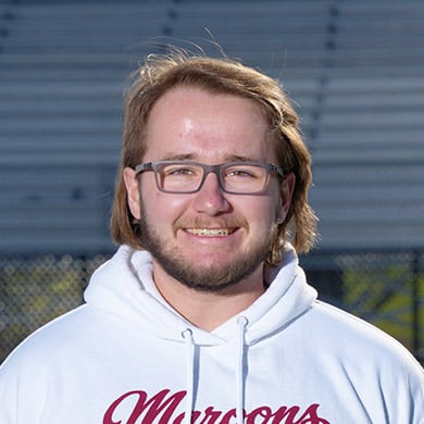JV boys lacrosse coach posing for the camera.