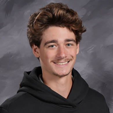 Sam Goulooze smiling at the camera.
